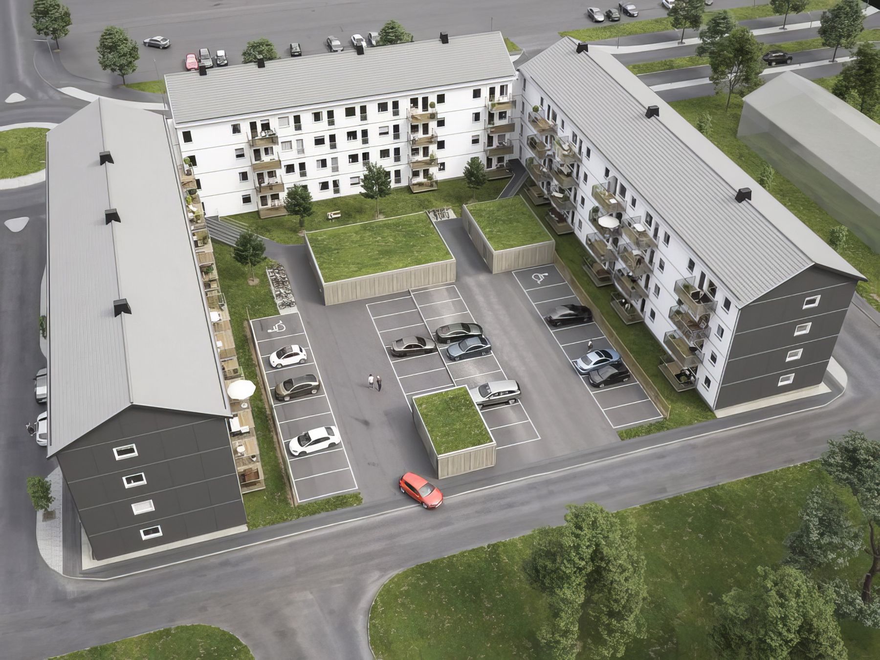 Föreningens tre hus runt en gemensam innergård med parkering, sett från ovan